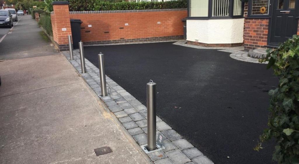 residential bollards protecting driveway from car theft